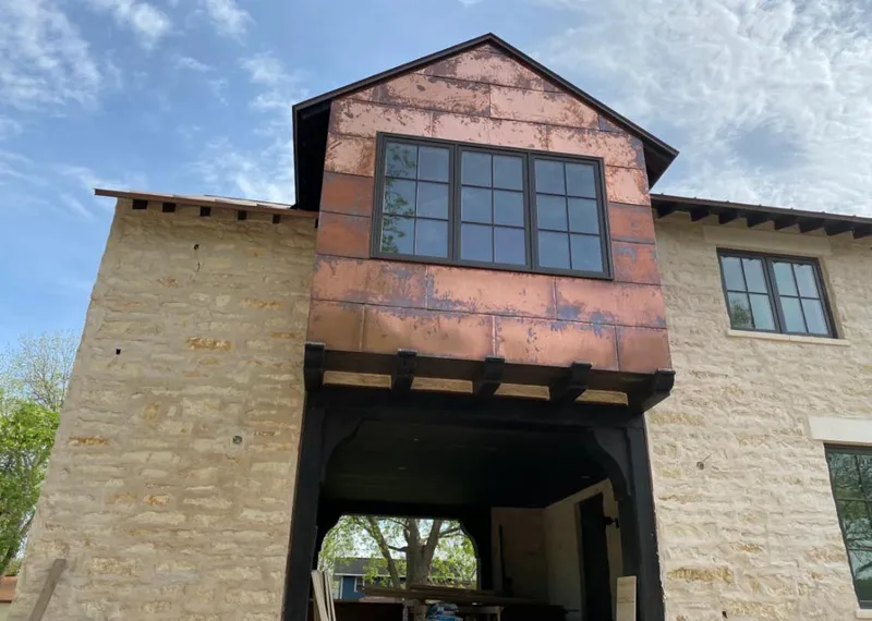 Copper metal panel facade on a stone building for Roof Repair in Picture Rocks